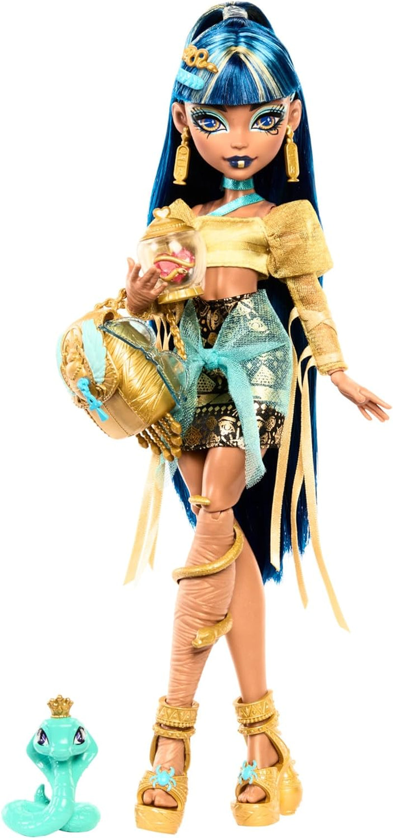 Păpușa Monster High Cleo De Nile într-o bluză aurie și o fustă cu mai multe straturi, include cobra Hissette și accesorii precum un ghiozdan, o gustare și un sul de hârtie igienică, HXH74